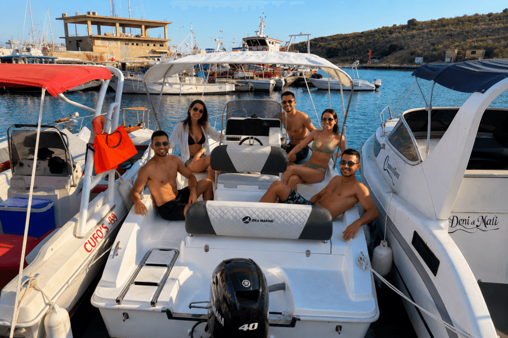 Small motorboat for rent in Sarande with group of friends enjoying a sunny day at sea
