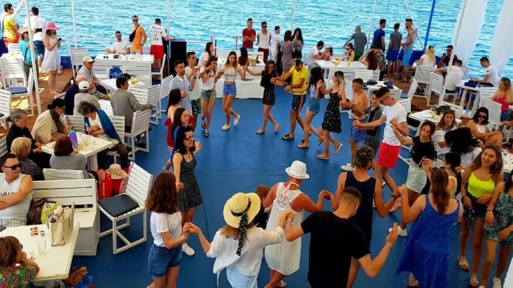 People dancing and enjoying a daily boat tour in Albania