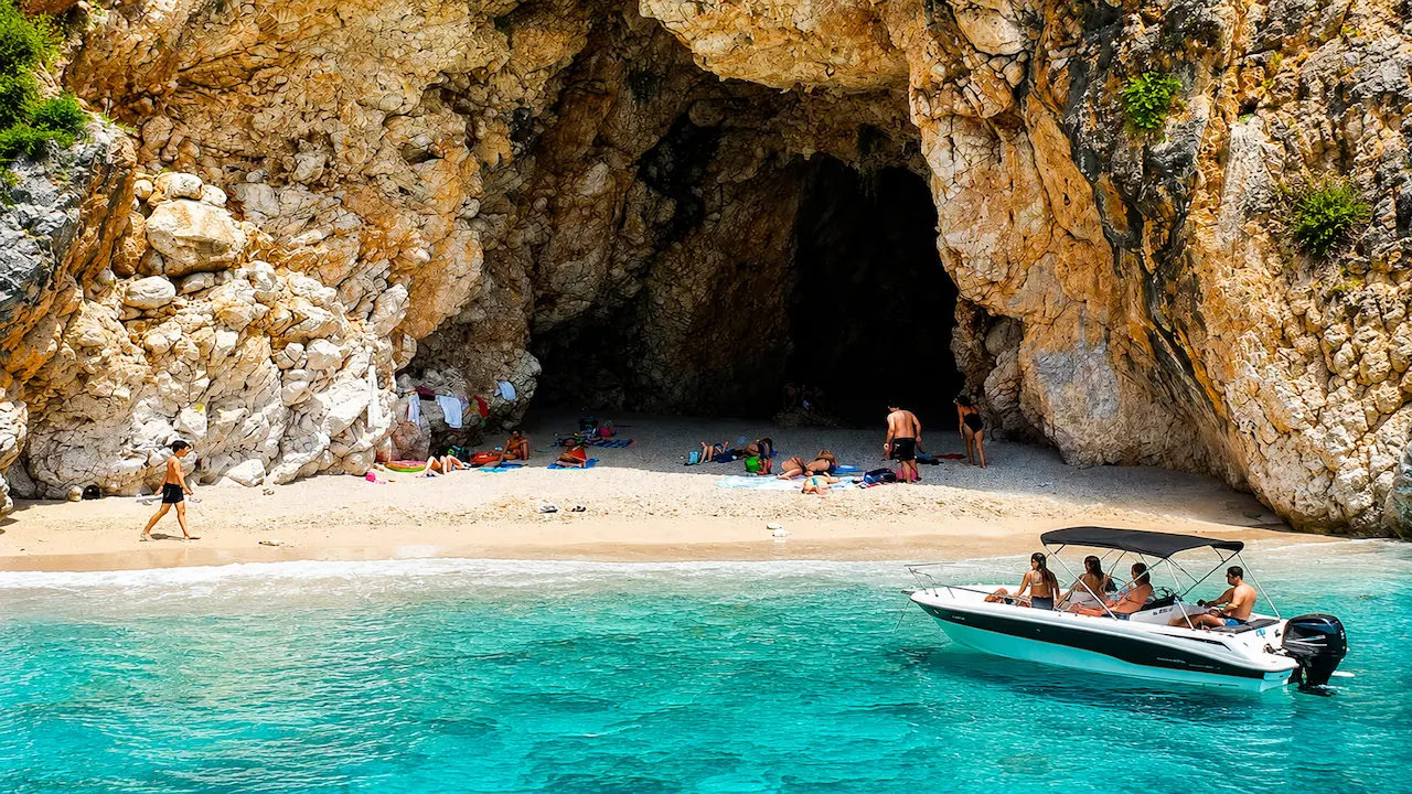 Pigeon Cave in Himare with crystal clear water and speedboat tour near the cave entrance
