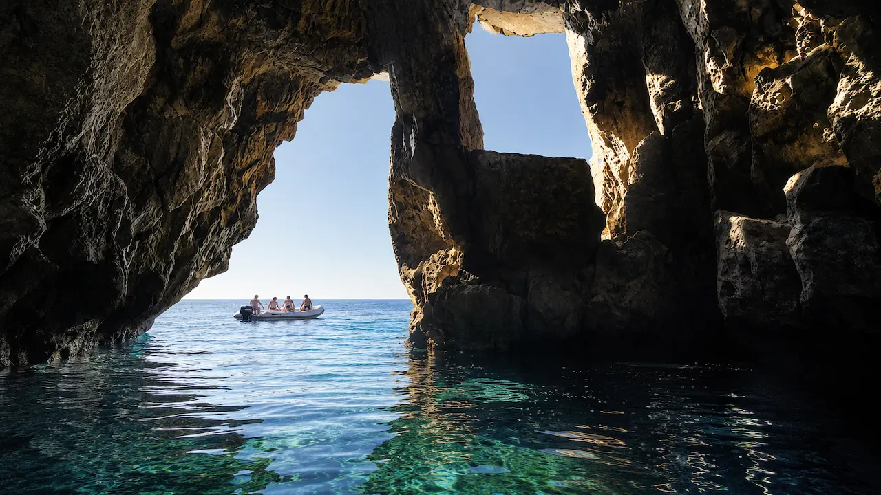 Pirate’s Cave in Himare viewed from inside the cave with a boat near the entrance