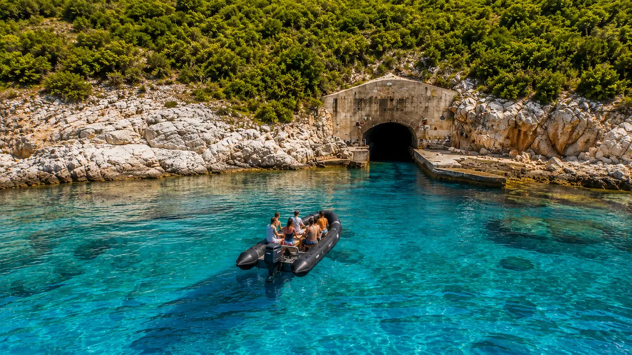 RIB boat tour near Porto Palermo Tunnel in Himare with crystal clear turquoise water