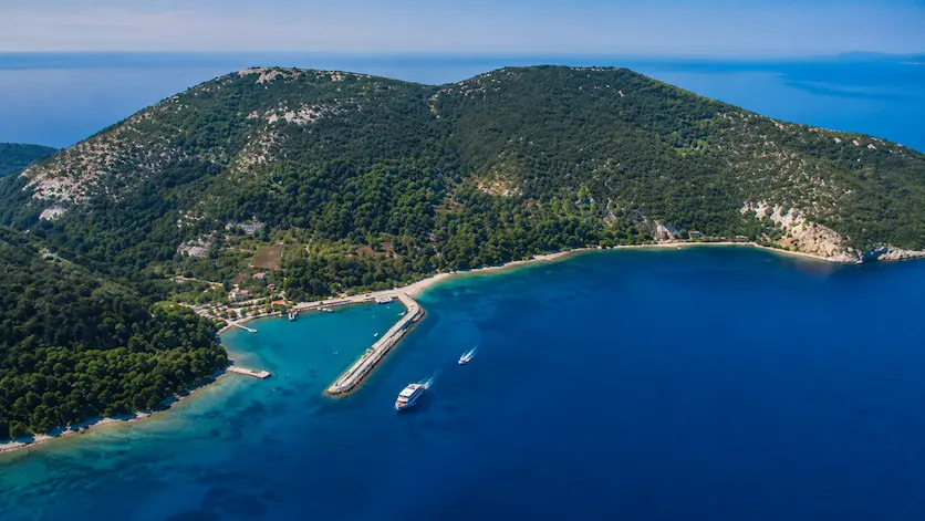 Aerial view of Sazan Island with tourist boats and crystal clear water in Vlore Albania